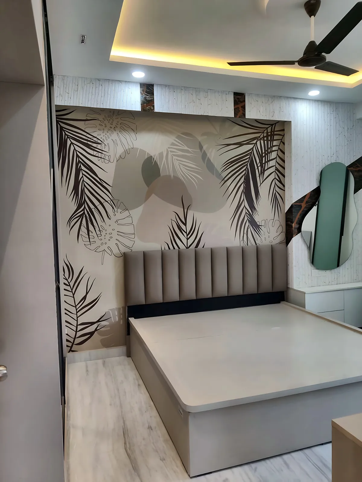 Bedroom with upholstered headboard, tropical feature wall and cove ceiling